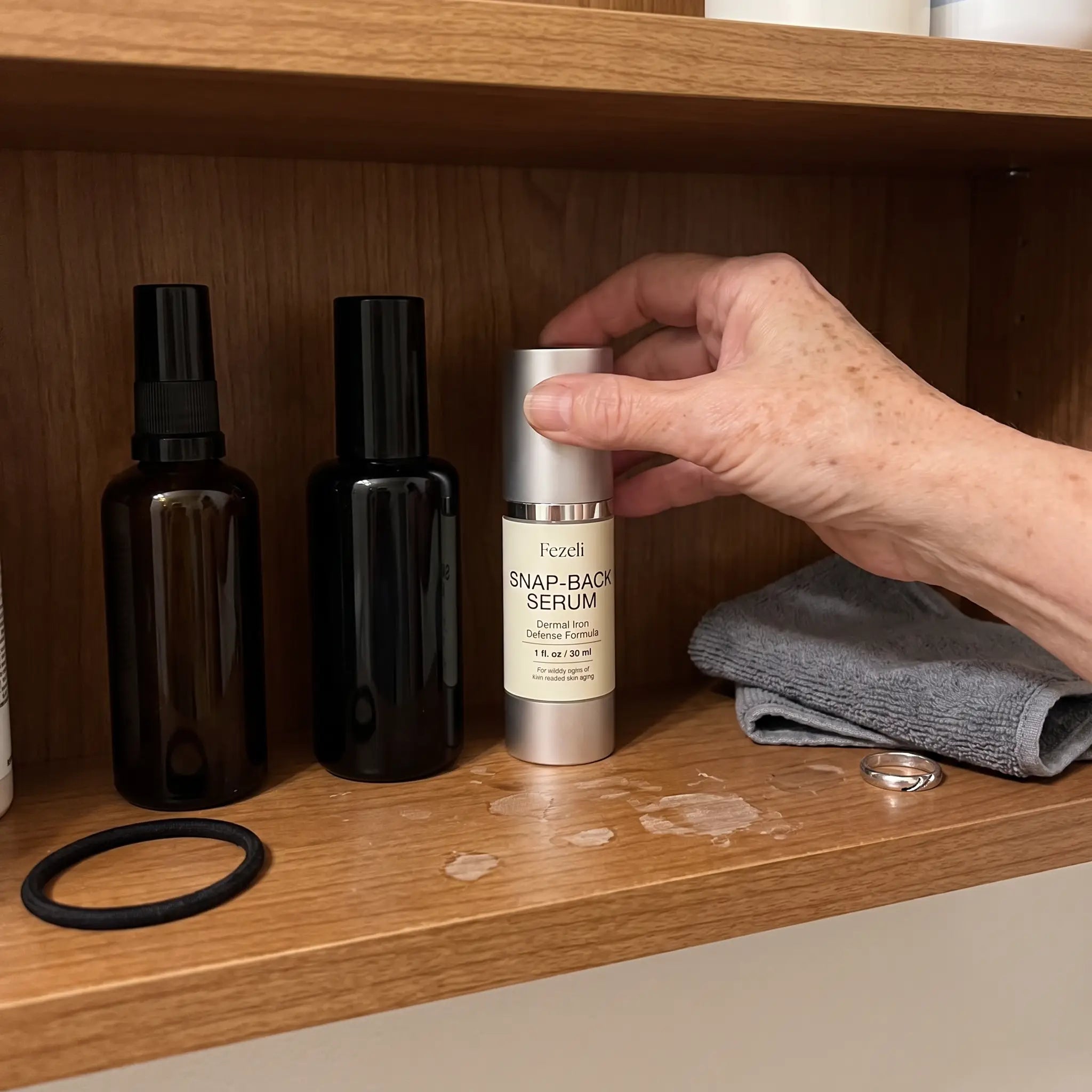 Three products on a shelf, Snap-Back being set down at the end of the line