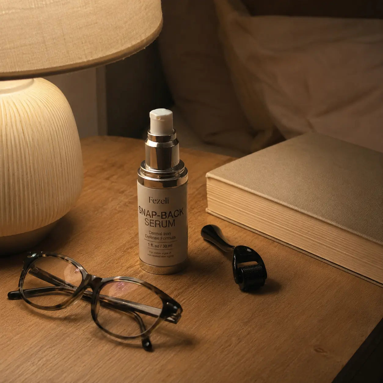 Snap-Back Serum and micro-channel roller on a nightstand